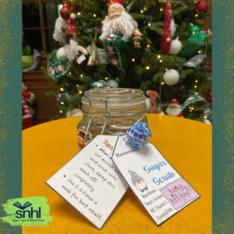 Sugar Scrub Jar with Labels on a table against a Christmas Tree background